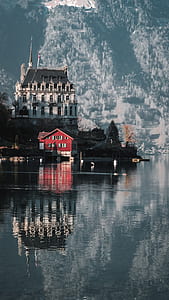 red and gray house near body of water thumbnail