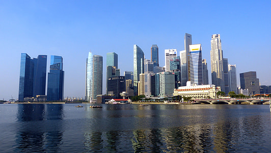 buildings near body of water under clear sky thumbnail
