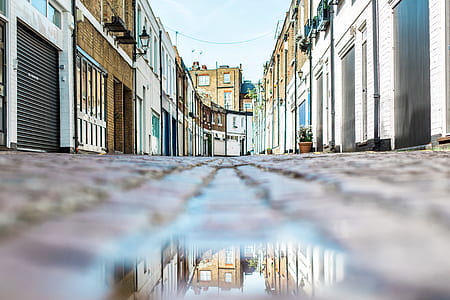 gray concrete road between buildings during daytime thumbnail
