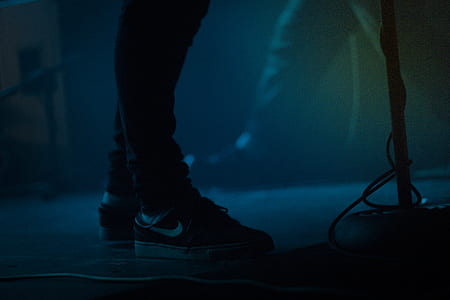 person wearing pair of black Nike low-top sneakers thumbnail