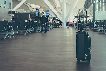 black softside luggage inside of airport thumbnail