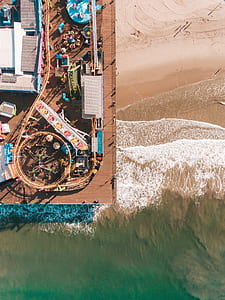 bird's eye view photo of amusement park near seashore thumbnail