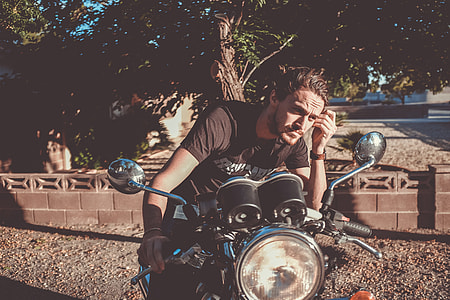 man riding motorcycle outdoors thumbnail