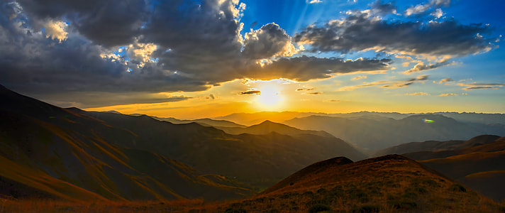 mountain under white clouds during golden hour thumbnail
