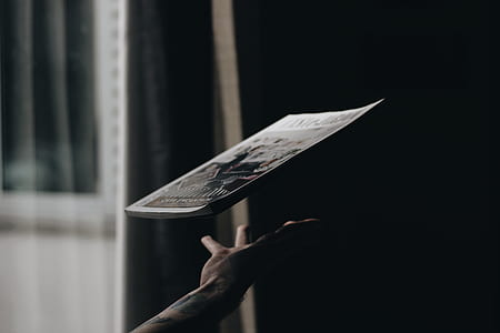 person catching magazine thumbnail