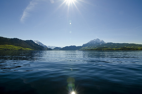 panorama photography of green mountain sorounded of body of water thumbnail