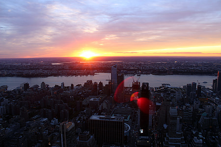 silhouette aerial photography of buildings and body of water thumbnail