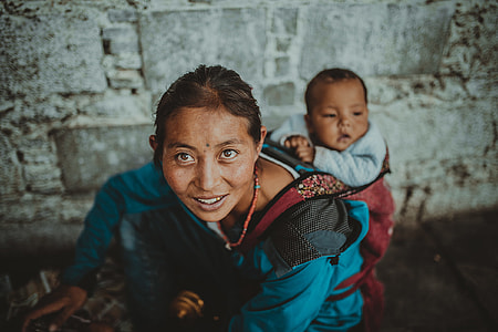 woman carrying baby by her back thumbnail
