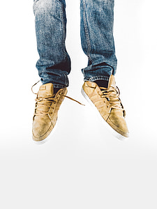 person wearing brown low-top sneakers thumbnail