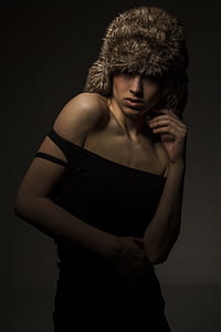 woman in black dress wearing fur hat thumbnail