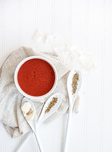 three white plastic spoon with red sauce thumbnail