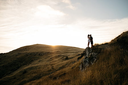 man and woman kissing standing on mountain kissing thumbnail