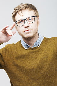 man wearing brown sweater and eyeglasses thumbnail