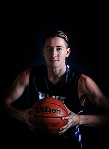 man holding Wilson basketball thumbnail