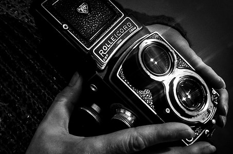 grayscale photo of person holding camera thumbnail