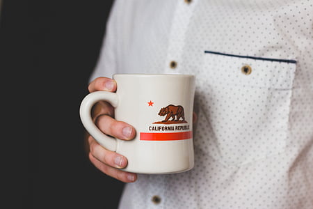 person holding white mug thumbnail