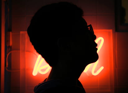 silhouette of a person beside LED signage thumbnail