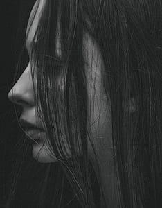 Grayscale Photo of hair partially covering girl's face thumbnail
