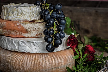 four stacked assorted cheese rolls with grapes thumbnail