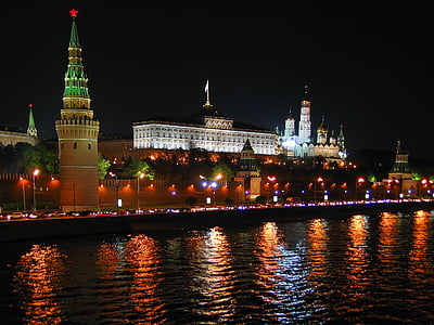 landscape photography of city building near body of water during night time thumbnail