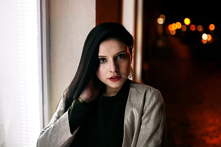 bokeh photography of woman wearing gray coat thumbnail
