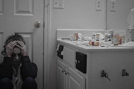 woman sitting near white wooden cabinet thumbnail