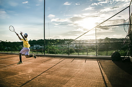 person playing tennis during daytime thumbnail
