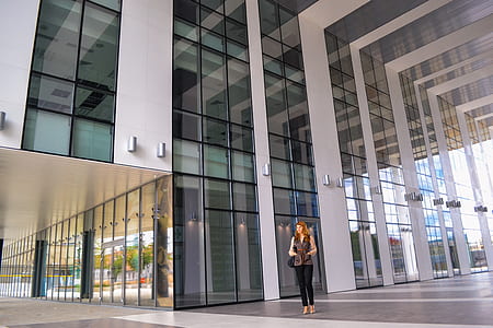 woman standing on front of white building thumbnail
