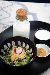 Vegetable Salad Beside Milk Bottle and Brown Sauce Dip on Round Black Tray thumbnail