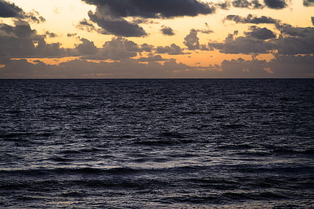 body of water under cloudy sky thumbnail