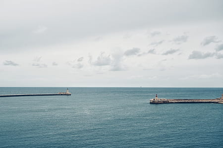 landscape photo of dock in sea at daytime thumbnail