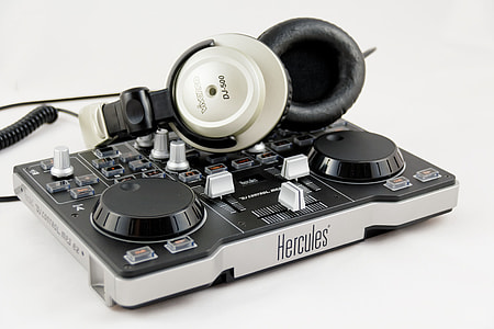 black and gray Hercules DC controller and corded headphone thumbnail