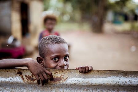 boy beside gray steel frame thumbnail