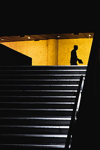 silhouette of man walking holding card thumbnail
