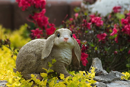 grey rabbit figurine in the garden thumbnail