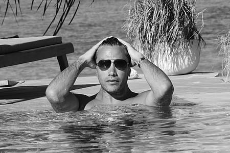 Grayscale Photo Of Man In Swimming Pool thumbnail