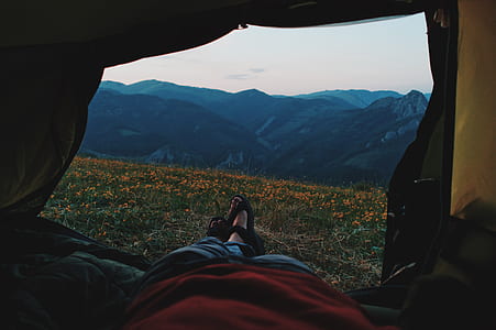 landscape photography of camper taking photo through mountain view under blue calm sky thumbnail