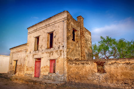 brown concrete building under blue sky at daytime photo thumbnail