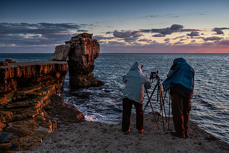 Two photographers make the most of golden hour on the spectacular Jurassic Coast in Dorset, England thumbnail