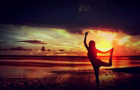 Woman Practising Yoga at the Beach thumbnail