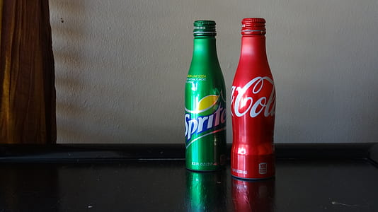 two Sprite and Coca-Cola bottles on furniture board thumbnail