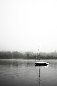 sail boat on lake during fog thumbnail