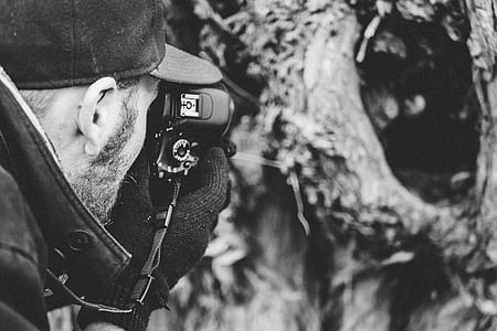 grayscaled photo of man taking picture thumbnail