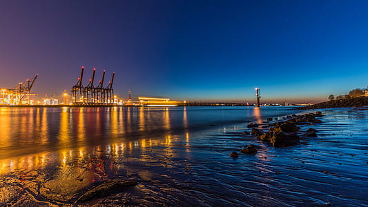 body of water near tower cranes thumbnail
