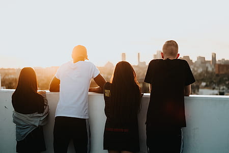 four boy and girl standing beside wall thumbnail