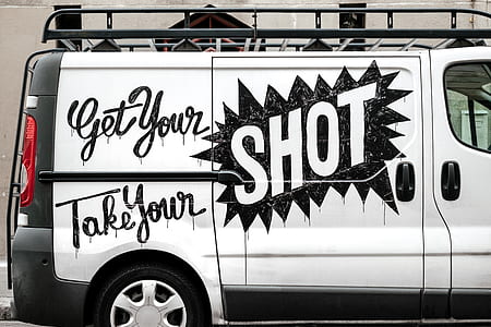 white panel van with decal stickers during daytime thumbnail