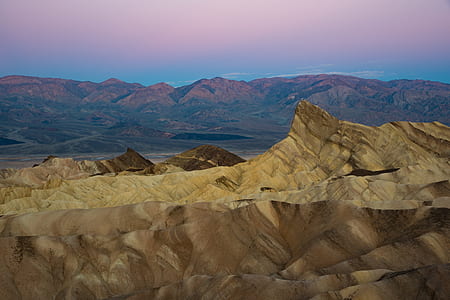 view of brown mountain under blue sky thumbnail