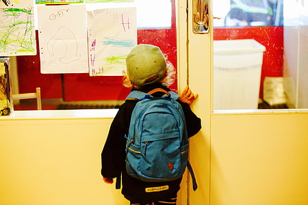 boy standing near door thumbnail