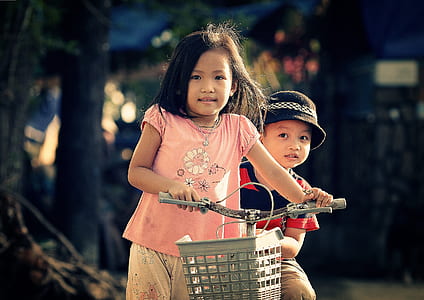 girl wearing pink crew-neck shirt using gray bicycle thumbnail