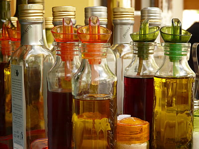 assorted-color liquid inside bottles thumbnail